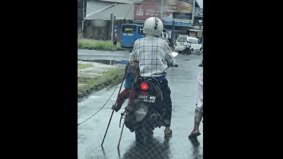 Monkey relaxes on motorbike at red light in Indonesia