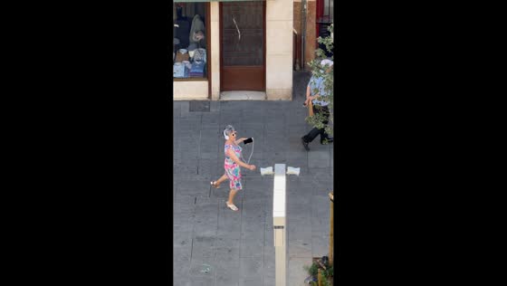 Woman dances joyfully through the streets of Zaragoza, Spain