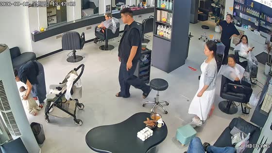 Baby falls from stroller during adjustment inside salon in Henan, China