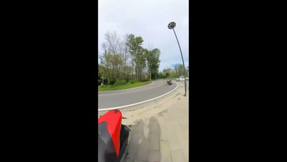 Motorcycle carrying passenger loses control on curve in Beijing, China