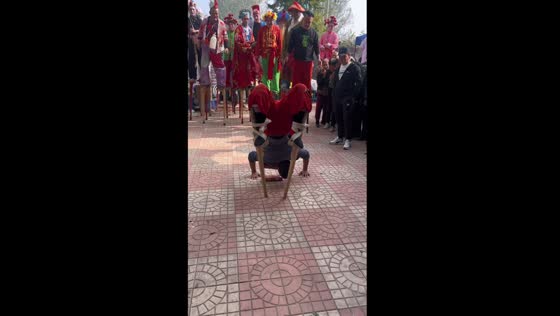 Stilt-walking maestro: acrobatic feat for cigarette reward