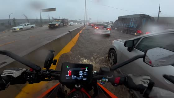 Motorcyclist turns back after struggling through floodwaters in Guadalajara, Mexico