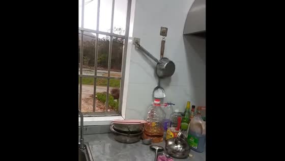Pan blown by strong wind hits another hanging pan in China
