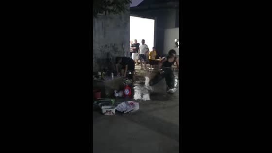Man slips and falls while chasing a woman with a basin during a water fight in Jiangsu, China