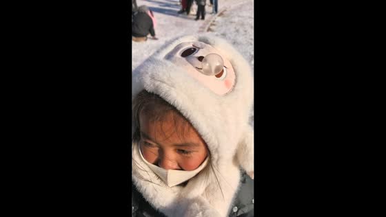 Girl’s winter hat reacts to her breathing in Liaoning, China