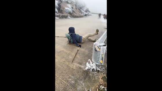 Man slides down slippery slope while hiking in Chongqing, China