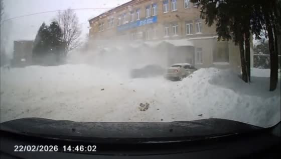 Snow falls from rooftop onto parked cars in Uglich, Yaroslavl, Russia