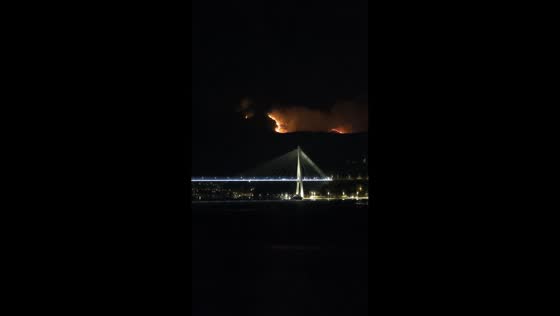 Nighttime wildfire seen burning across distant hillside from Dubrovnik, Croatia