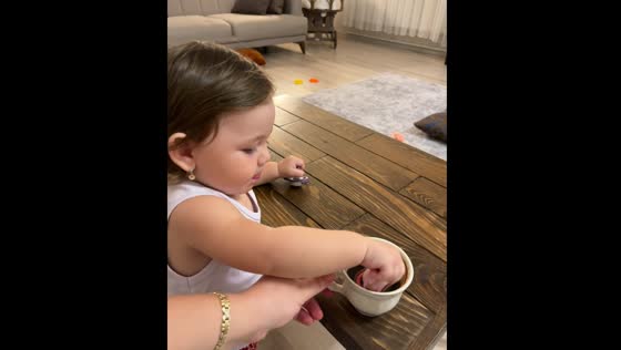 Toddler drinks coffee with pacifier in Erzincan, Turkey