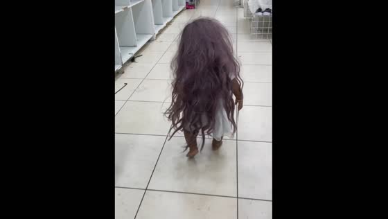 Baby girl strolls through mall wearing long wig in India