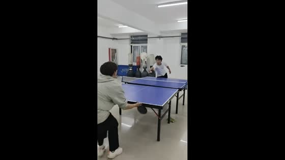 Friends share laughter during playful ping pong trick in Jiangxi, China
