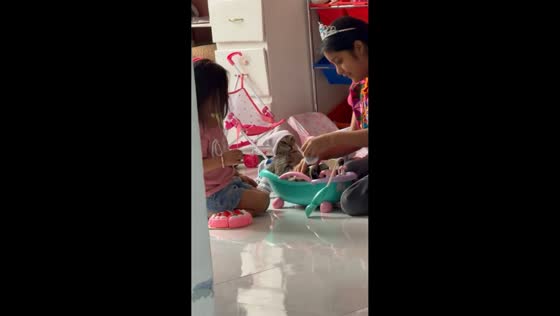 Children dress up kitten during playtime in Torreón, Mexico