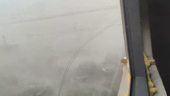 Powerful rainstorm reduces visibility across field in Henan, China