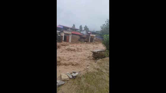 Floodwaters surge through residential area in Henan, China