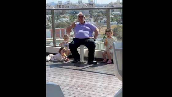 Grandpa and grandkids enjoy popsicles on the balcony