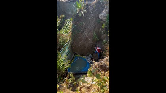 Brave staff member retrieves phone from 10-foot wishing well in Baguio City, Philippines