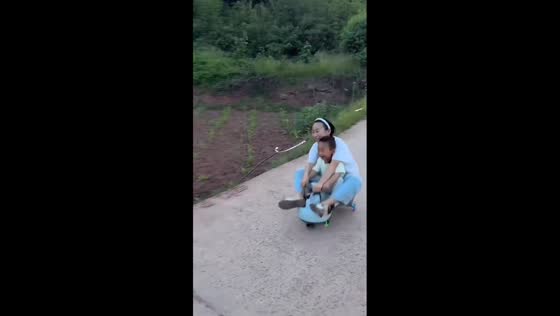 Siblings tumble off twist car toy on slope in Hebei, China