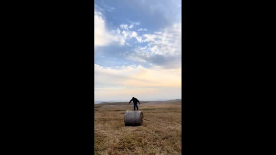 Man runs on haystack roll in Inner Mongolia, China