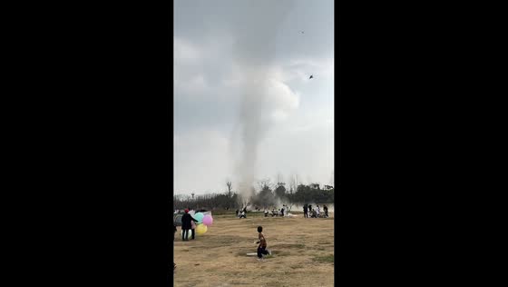 Swirling dust devil captivates visitors in public park in Sichuan, China