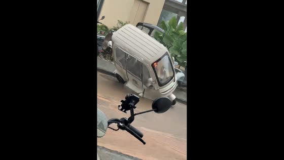 Rider avoids injury after e-bike tips over in flooded street in Yunnan, China,