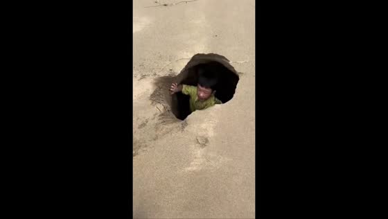 Child falls into hidden sand hole on a beach in Shandong, China