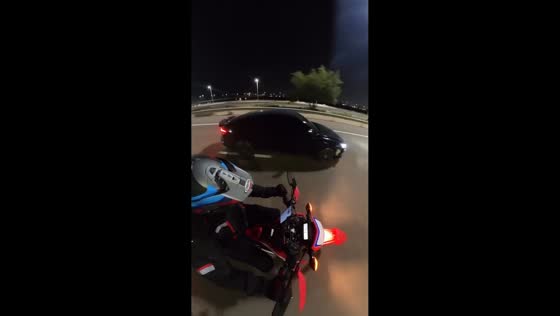 Motorcyclist keeps balance after being struck from behind on highway in Abu Dhabi, UAE