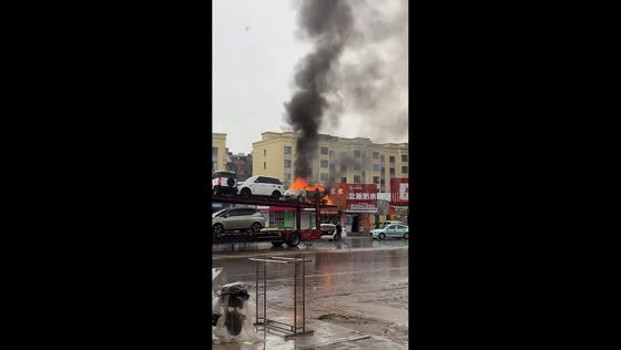 Car transporter catches fire as flames engulf vehicle in Liaoning, China