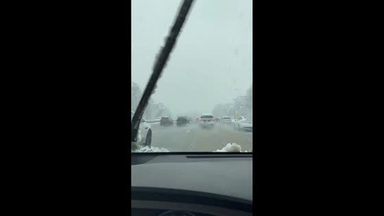 Snow begins to accumulate during morning drive in New York, USA