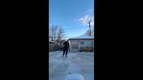 Skater glides on ice formed by flooding in Detroit, Michigan, USA