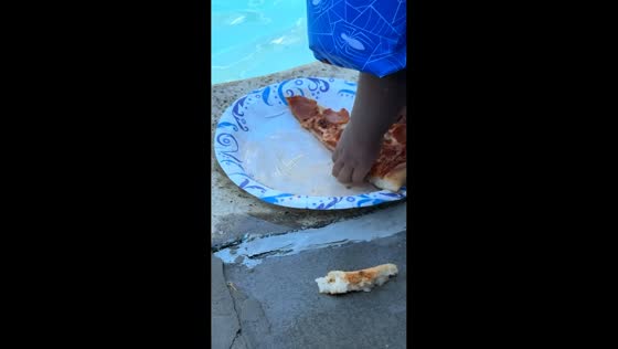 Child picks up pool-soaked pizza slice in Lodi, California