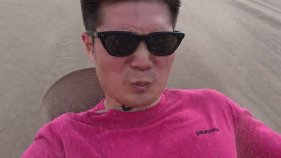 Man slides down sand slope and ends up covered in sand in Gansu, China
