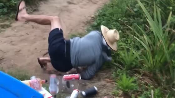 Person falls and drops belongings near beach in Brazil
