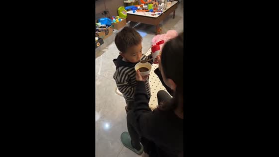Young boy proudly drinks his medicine in Hubei, China