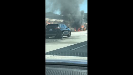 Vehicle fire sparks brush fire along 15 Freeway in Cajon Pass, California, USA