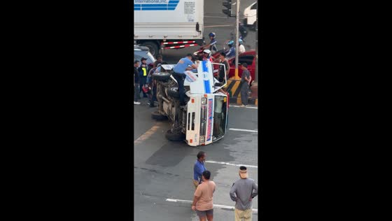 Bystanders and police assist after ambulance tips over in Parañaque, Philippines