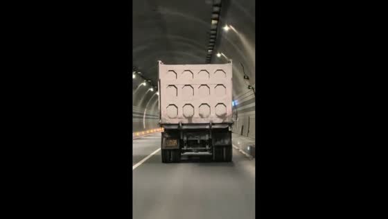 Puzzle-like truck lights reflect beautifully inside tunnel in Guangxi, China