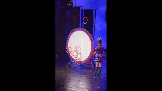 Woman and knife thrower create coordinated hoop display on stage in Jiangxi, China
