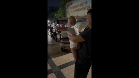 Baby dances happily to upbeat music at a park in Henan, China