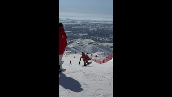 Skier in horse costume glides and spins down snowy slope in Beijing, China