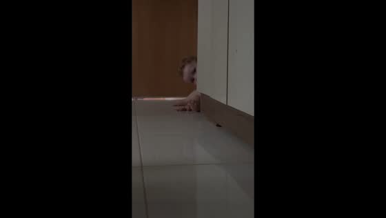 Toddler peeks out hide-and-seek in Rubiataba, Brazil