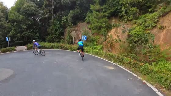 Cyclist loses balance on a sharp mountain curve in Zhejiang, China