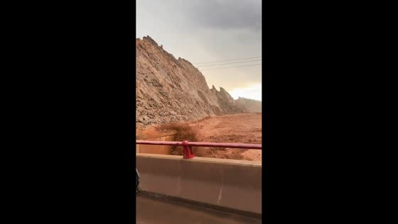 Flash flood sends debris rushing through Duku Highway canyon in Xinjiang, China