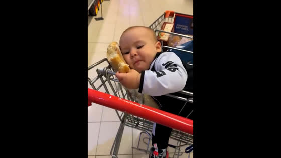 Baby lies on loaf of bread and eats it in Belgrade supermarket