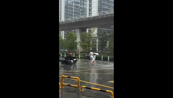 Motorcyclist blown off balance during Typhoon Bavi in Zhejiang, China