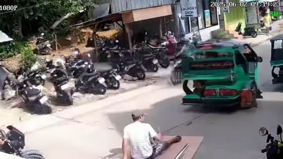 Man slips off moving plywood on busy street in Palawan, Philippines