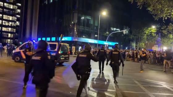 Riot police charge protesters during eviction demonstration in Madrid, Spain