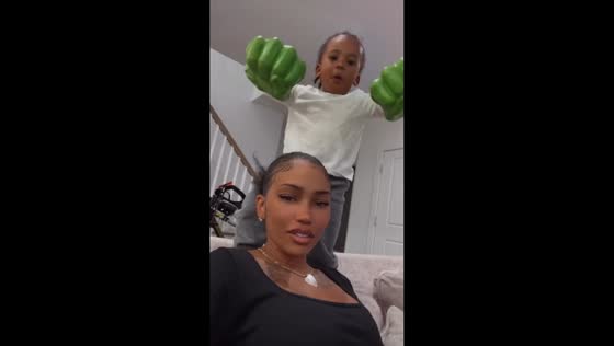 Child playfully taps woman with oversized Hulk gloves in New Jersey, USA