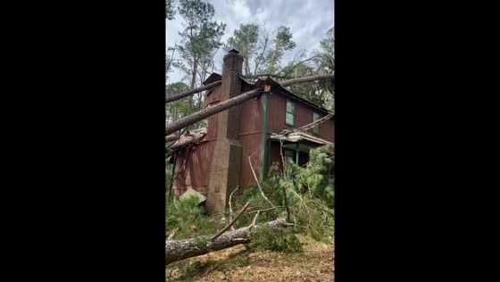 House damaged by fallen trees during Hurricane Helene in Martinez, Georgia