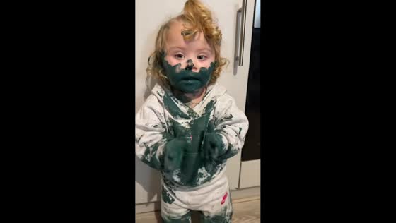 Toddler covered in paint enjoys playful decorating moment in Preston, UK