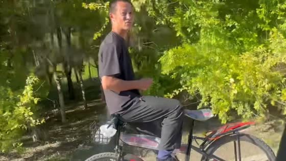 Cyclist rides bicycle backwards on highway in Tianjin, China
